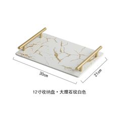 a white marble tray with gold handles