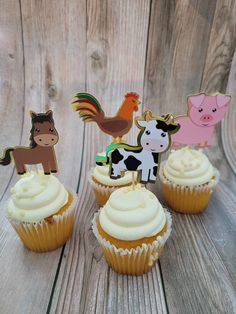 cupcakes decorated with farm animals on top of them