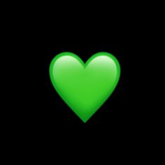 a green heart on a black background with the light reflecting off it's side