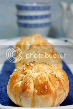 two loaves of bread sitting on a blue and white plate