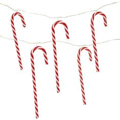 three candy canes are hanging on a string