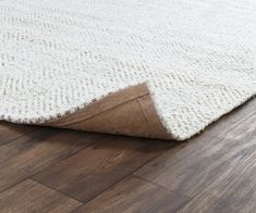 a white rug on the floor with brown trim