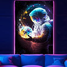 an astronaut holding a crystal ball in his hand while standing next to a blue couch