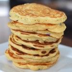 a stack of pancakes sitting on top of a white plate