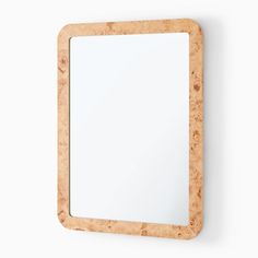 a wooden mirror hanging on the wall with a white background and no image in it