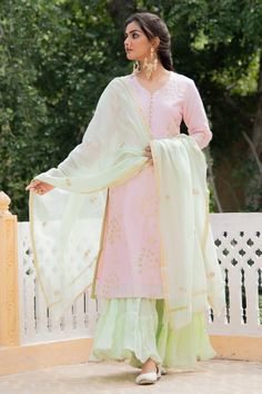 Baby pink chanderi kurta with gota jaal detailing on the neckline, sleeves and hemline. Comes with pista green dupatta adorned with gota flowers and ghera sharara in soft mul mul adorned with gota detailing.
Component: 3
Embroidered
Neckline: V Neck
Sleeve Length: Three Quarter
Fabric: Kurta and Dupatta: Chanderi; Pant: Mul Mul
Color: Green,Pink
Gota trims
Side slits
Gathered tiers
 - Aza Fashions Pant Embroidery, Kurta And Dupatta, Chanderi Dupatta, Suit Combinations, Pista Green, Kurta Sharara, Sharara Set, Festive Wear, Embroidered Neckline