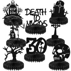 black and white paper cut outs with skulls, tombstones and trees in the shape of numbers