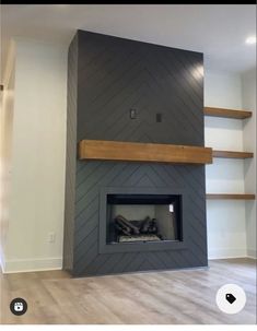 an empty room with a fireplace and shelves