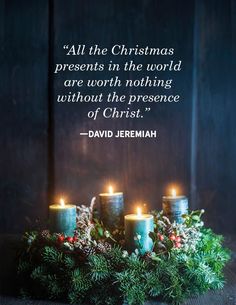 candles are lit in front of a wreath with the words, all the christmas presents in the world are worth nothing without the presence of christ