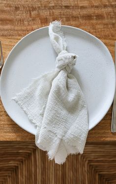 a white plate topped with a napkin and fork