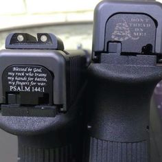 two black parking meters sitting next to each other