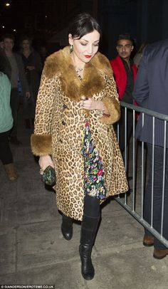 a woman in a leopard print coat and black boots