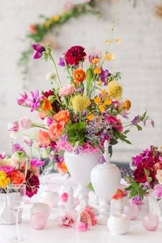 a table with flowers and vases on it