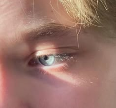 a man's blue eyes are shining brightly