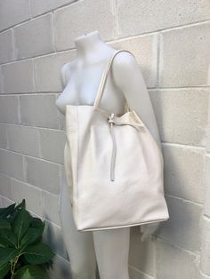 Large tote leather bag in a very light BEIGE shade. Broken white shopper bag natural GENUINE leather. Large enough for books or a laptop, tablet, cosmetics bag etc. Creamy white Leather shopper. The inside of the bag is not lined (although properly finished!) . We added a small leather pouch on the inner part of the bag . The bag can be closed by 2 leather straps attached to each side. Excellent quality soft but strong genuine leather. The color of the bag in this listing is a very light beige c Bag For Books, Small Leather Pouch, Tote Leather Bag, Suede Tote Bag, Slouch Bags, Tablet Bag, Small Coin Purse, White Tote Bag, Broken White