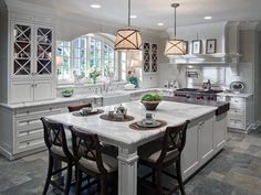 a large kitchen with an island in the middle