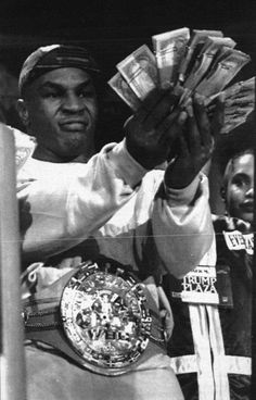 a black and white photo of a man holding money