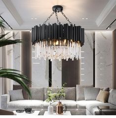 a living room with couches and a chandelier