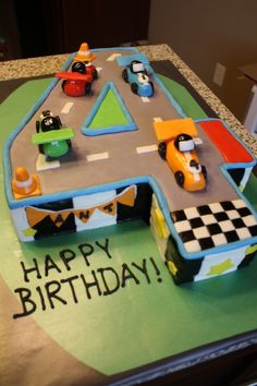 a birthday cake that is shaped like a race track