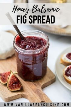 a jar filled with fig spread on top of a wooden cutting board