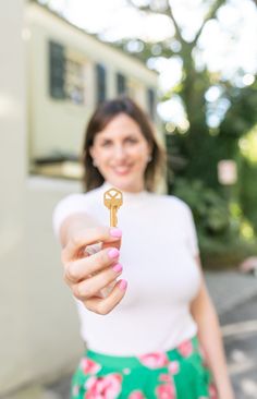 a woman holding a key in her hand