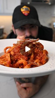 a man holding a plate with some food on top of it in front of his face