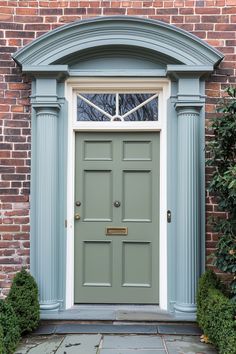 a green front door on a brick building