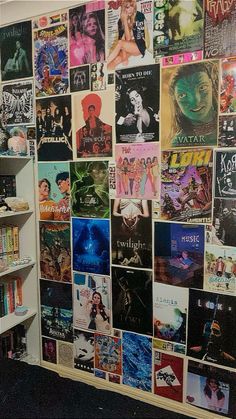 there is a wall covered with posters and movies on the walls in this room as well as bookshelves