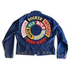 a jean jacket with the words rock and roll on it's back, sitting against a white background