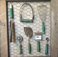 an assortment of kitchen utensils are displayed in a shadow box on the wall