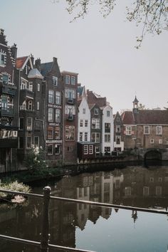 a river running through a city with lots of tall buildings on the side of it