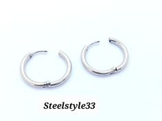 two silver hoop earrings on a white background with the words steelstyles233