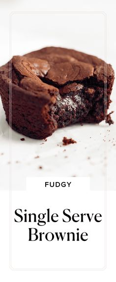 a single serve brownie on a white plate with the words fuddy above it