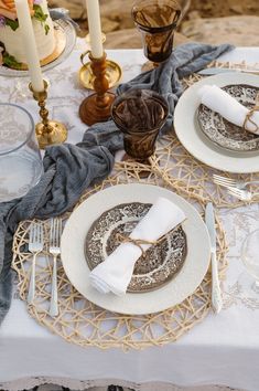 the table is set with plates, silverware and napkins for two people to eat