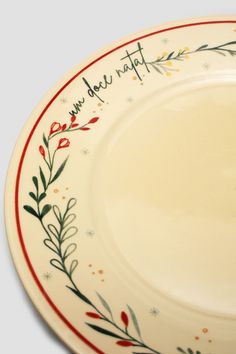 a white plate with red and green designs on the rim that says, we do not eat