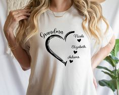 a woman wearing a t - shirt that says grandma made with hearts and an arrow