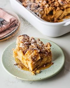 a piece of cake on a plate next to a casserole dish filled with baked goods