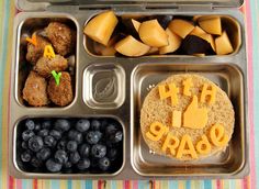 a lunch box with blueberries, bread and fruit in it that says happy birthday