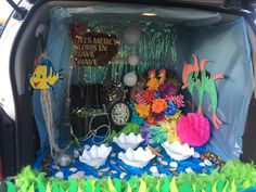 the trunk of a car is decorated with fish and other decorations for an underseam party