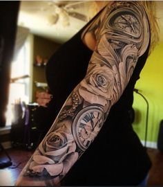 a woman's arm with tattoos on it and an image of a clock in the middle