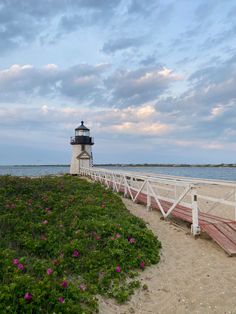 a light house sitting on top of a sandy beach