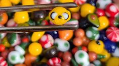 a bunch of candy balls that are next to each other in the shape of a smiley face