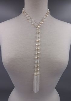 "https://www.etsy.com/shop/MYGEMSROCK - A trend-right lariat necklace with tassels that are hand-wired with cultured pearls and crystals, a unique designed necklace with extensive workmanship.  - 3 crystal options: opalite, jet black, champagne - Total Length: 50\"L. Necklace length: 47\".Tassel Length: 3\"L. - Beads: Cultured freshwater pearls; rice shape: 6-7mm, potato shape: 8-9mm. Crystal beads;" Adjustable Long Lariat Necklace With Pearl Drop, Elegant Adjustable Lariat Necklace With Round Beads, White Single Strand Lariat Necklace, Elegant Adjustable Beaded Lariat Necklace, Elegant Beaded Lariat Necklace, Adjustable White Dangle Backdrop Necklace, White Adjustable Dangle Backdrop Necklace, Adjustable Pearl Beaded Lariat Necklace, Adjustable Pearl Lariat Beaded Necklaces