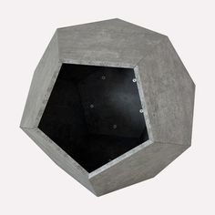 an octagonal concrete object with holes in the center