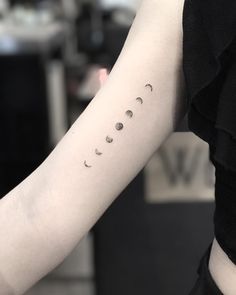 a person with a tattoo on their arm that says, phases of the moon tattoo i tumbr