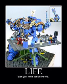 an image of a blue warhammer on a table with some bottles and other items