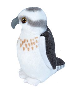 a stuffed bird sitting on top of a white surface