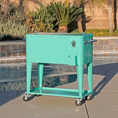 a blue cooler sitting next to a swimming pool