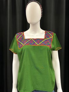 This is one of a kind Huipil or top handmade in Nebaj Quiche, Guatemala. It is lightweight and very comfortable to wear. The colors and design on the top are stunning. Pair with shorts or jeans for a casual look. Green Floral Embroidered Crew Neck Blouse, Green Embroidered Crew Neck Blouse, Green Embroidered Relaxed Fit Blouse, Green Blouse With Floral Embroidery And Relaxed Fit, Green Embroidered Blouse With Relaxed Fit, Green Crew Neck Blouse With Floral Embroidery, Summer Green Blouse With Embroidered Neckline, Green Crew Neck Blouse For Vacation, Green Cotton Embroidered Top For Summer