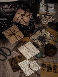 an old fashioned typewriter surrounded by papers and other items on a wooden table top